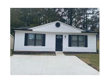 Charming single story house featuring a symmetrical front facade, white siding and minimalist landscaping at 4778 Pebble Trce, Buford, GA 30518
