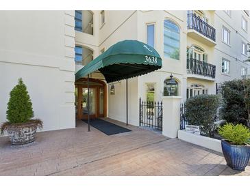 Elegant building entrance with covered awning and well-manicured landscaping creates a welcoming arrival at 3638 Peachtree Rd # 306, Atlanta, GA 30319