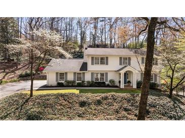 Charming two-story traditional home with a well-maintained lawn and mature trees at 440 River Valley Rd, Atlanta, GA 30328