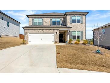 Charming two-story home featuring brick accents, a two-car garage, and well-maintained landscaping at 4779 Mock Orange Sw St, Atlanta, GA 30331