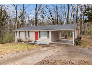 Charming single-story home with a carport and a bright red front door at 3552 Meadowview Dr, Lithia Springs, GA 30122