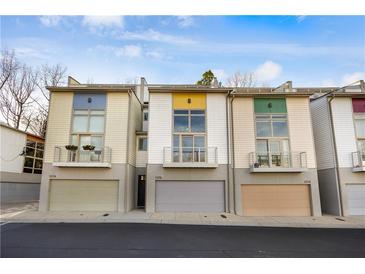 Charming townhomes featuring colorful accents, balconies, and attached garages at 1376 Stirling Nw Cir, Atlanta, GA 30318