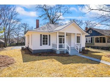 Charming renovated single-story home featuring fresh paint, manicured yard and inviting front porch at 34 N Broad N St, Porterdale, GA 30014