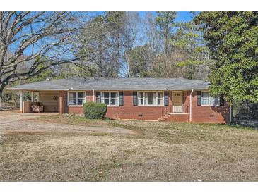 Charming brick ranch-style home with a covered carport and traditional window shutters at 1276 Clay Sw Rd, Mableton, GA 30126