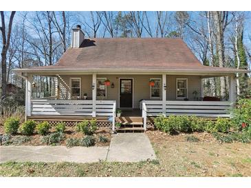 Charming single-story home featuring a welcoming front porch with beautiful landscaping at 3870 Wyntuck Nw Ct, Kennesaw, GA 30152