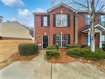 Charming brick home with well-maintained landscaping and a cozy front entrance, nestled under a bright blue sky at 3153 Kingswood Gln, Decatur, GA 30034