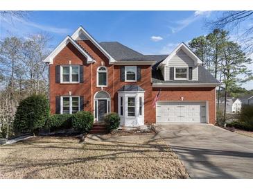 Beautiful two-story brick home featuring an attached two-car garage and manicured front yard at 2447 Tift Nw Ct, Kennesaw, GA 30152
