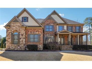 Two-story home with a combination of brick and stone facade, complemented by meticulously maintained landscaping at 2916 Kings Walk Ave, Marietta, GA 30062