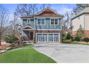 Charming two-story home with blue siding, stone accents, and a well-manicured front yard at 4160 Tilly Mill Rd, Atlanta, GA 30360