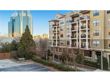 Attractive condominium building with multiple balconies and views of the city skyline at 799 Hammond Dr # 219, Atlanta, GA 30328