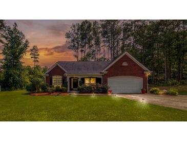 Charming brick home with well-manicured lawn and inviting curb appeal at sunset at 25 Horseshoe Ct, Covington, GA 30014