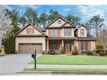 Beautiful two-story home featuring manicured lawn, complemented by a two car garage, and colorful landscaping at 2964 Perimeter Cir, Buford, GA 30519