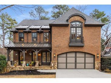 Stunning two-story brick home with a covered porch and stone accents creates a welcoming and elegant facade at 2871 Parkridge Ne Dr, Brookhaven, GA 30319