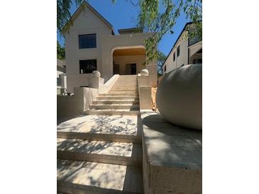 Grand staircase leading to the covered entrance with stone balustrades offers inviting curb appeal at 1366 Wessyngton Ne Rd, Atlanta, GA 30306