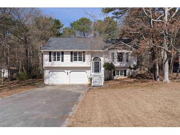 Charming two-story home with a well-manicured lawn, attached two car garage, and classic architectural details at 70 Nw Willow Bend Dr, Cartersville, GA 30121