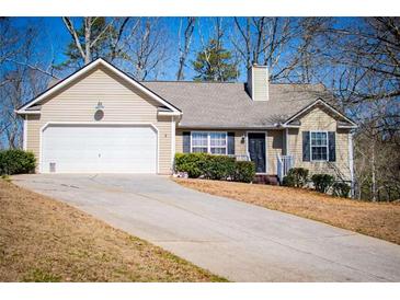 Charming single-story home features a two-car garage and a cozy front porch at 185 Whetstone Way, Villa Rica, GA 30180