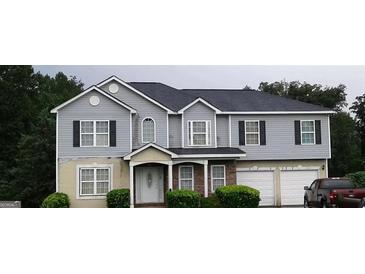 Two-story home with gray siding, black shutters, and an attached two-car garage at 3551 Northgate Cv, Ellenwood, GA 30294