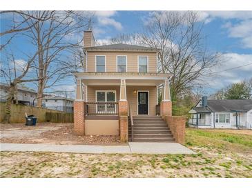 Charming two-story home with a welcoming front porch and traditional architectural details at 3040 Washington Rd, Atlanta, GA 30344