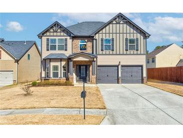 Charming two-story home with a well-manicured lawn and attached two-car garage at 6188 Riddle Ct, Douglasville, GA 30134