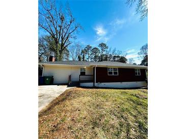 Cozy home with a brick and siding exterior and a well-maintained lawn at 2182 Rosewood Rd, Decatur, GA 30032