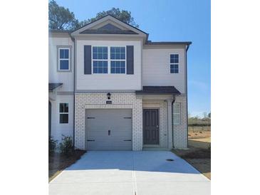 Charming townhome featuring a one-car garage, neutral paint scheme, and a welcoming front entrance at 2284 Jamin Bnd # 18, Lithonia, GA 30058