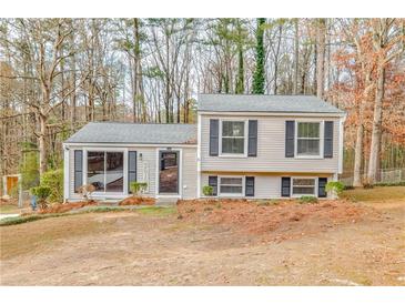 Charming two-story home with neutral siding, black shutters, and well-maintained landscaping at 3265 Newcastle Way, Snellville, GA 30039