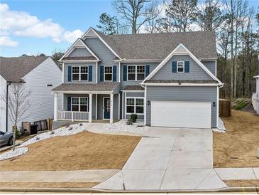 Charming two-story home with blue shutters and a well-manicured front yard at 614 Edgemore Rd, Canton, GA 30114