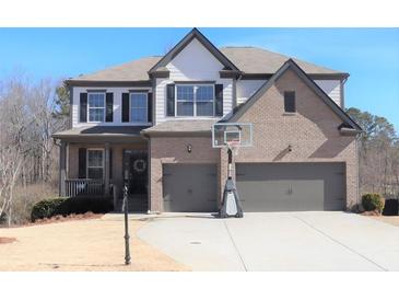 Charming two-story home featuring a two-car garage, basketball hoop, and well-maintained front yard at 5315 Austrian Pine Ct, Cumming, GA 30040