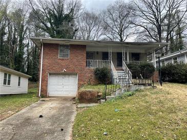 Traditional brick home with a single-car garage and a small front yard at 70 Rockmart Nw Dr, Atlanta, GA 30314