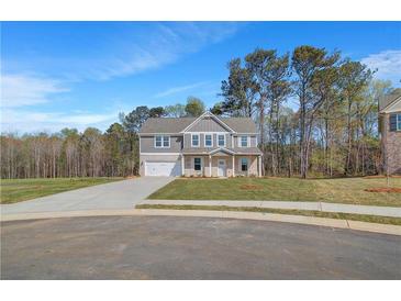 New two-story home features a two-car garage and a well-manicured front yard at 132 Felicity Pike, Locust Grove, GA 30248