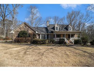 Charming brick home with a well-manicured lawn and inviting front porch at 2984 Superior Dr, Dacula, GA 30019