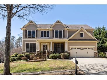 Charming two-story home featuring a manicured front yard and a two-car garage at 4012 Grand Park Ne Dr, Suwanee, GA 30024