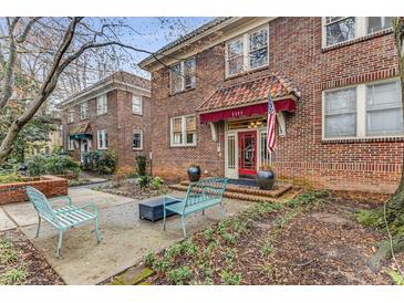 Charming brick apartment building entrance with manicured landscaping and inviting outdoor seating at 1111 Briarcliff Ne Pl # 2, Atlanta, GA 30306