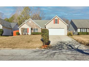 Charming one story home features a 2-car garage, neutral siding and lovely stone accents at 395 Shadetree Ln, Lawrenceville, GA 30044