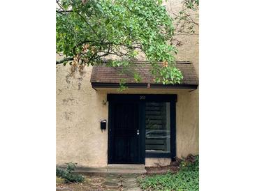 Inviting front entrance features a black door with clear house number above at 207 Tiburon Dr, Stonecrest, GA 30038