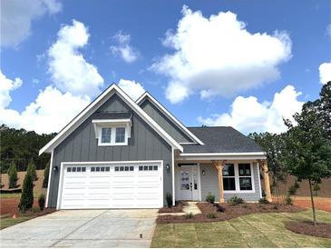 Charming single-story home with gray siding, white trim, a two-car garage, and a cozy front porch with wood supports at 33 Cambridge Ln, Dallas, GA 30157