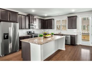 Modern kitchen features granite countertops, stainless steel appliances, and dark wood cabinetry at 4358 White Spruce Aly, Doraville, GA 30360