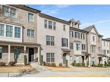 Charming townhouse with light brick, covered front porches, and lush landscaping at 4358 White Spruce Aly, Doraville, GA 30360