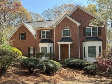 Charming brick two-story home with manicured landscaping and mature trees in a desirable neighborhood at 5960 Camelia Dr, Douglasville, GA 30135