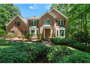 Beautiful brick home with manicured landscaping and a charming entrance nestled in a lush, green setting at 5960 Camelia Dr, Douglasville, GA 30135