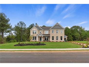 Beautiful brick two-story home with manicured lawn and professional landscaping showcasing curb appeal at 133 Frontier Way, Mcdonough, GA 30253