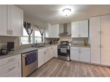 Bright kitchen featuring white cabinets, stainless steel appliances, and granite countertops at 4289 Post Rd, Winston, GA 30187