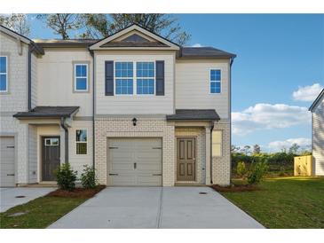Charming townhome with a brick facade, attached garage, and well-manicured front yard at 2270 Jamin Bnd # 12, Lithonia, GA 30058