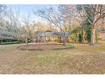 Charming brick home with well-maintained front yard and mature trees at 2330 Bonnybrook Way, East Point, GA 30344