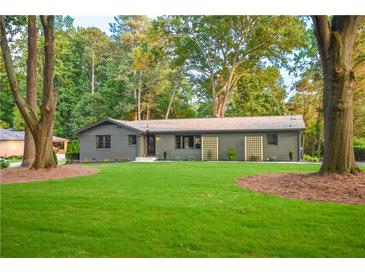 Charming one story home with green lawn and mature trees offering shade and curb appeal at 642 Austin Se Dr, Smyrna, GA 30082