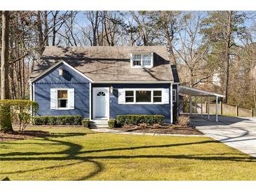 Charming blue home with a well-manicured front lawn and convenient covered parking at 2858 Skyland Ne Dr, Brookhaven, GA 30341