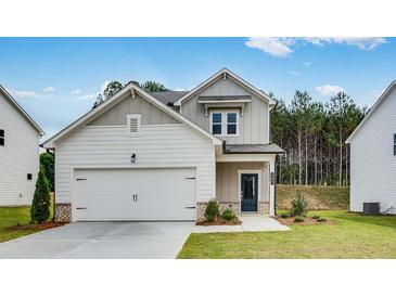 Charming two-story home with a two-car garage and a well-manicured front lawn at 203 Groveton Ct, Euharlee, GA 30145