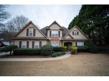 Charming two-story home with a well-manicured lawn and mature landscaping at 3402 Blaisdell Rd, Buford, GA 30519