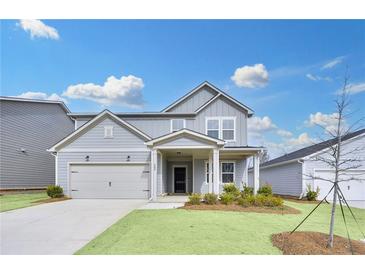Charming home with a gray exterior, well-manicured lawn, and a two-car garage on a sunny day at 362 Rock View Ln, Covington, GA 30016