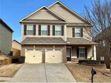 Charming two-story home with a well-maintained front yard and two-car garage at 2359 Brynfield Cv, Suwanee, GA 30024